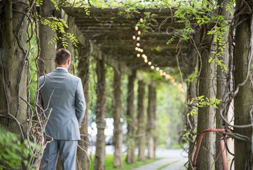 The groom waiting for the bride under the wisteria, Kaitlyn Ferris photo